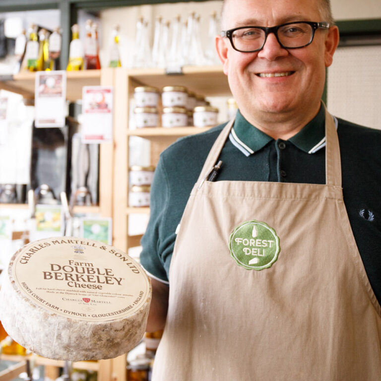 Simon Jones from Forest Deli holding a whole truckle of cheese